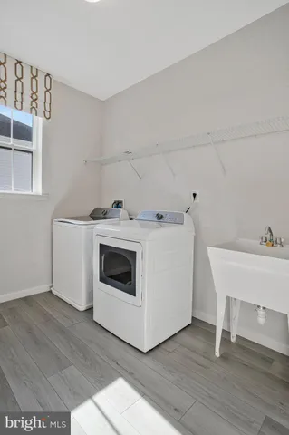 an empty room with a window and a ceiling fan