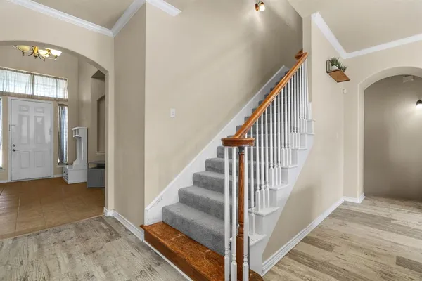 a view of entryway and hall with wooden floor