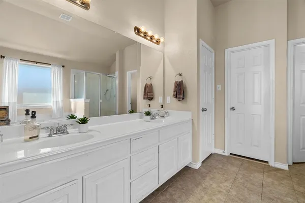 a bathroom with a tub a sink and a window