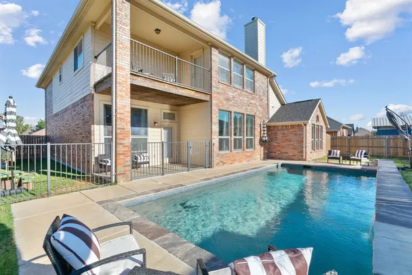 a backyard of a house with barbeque oven table and chairs