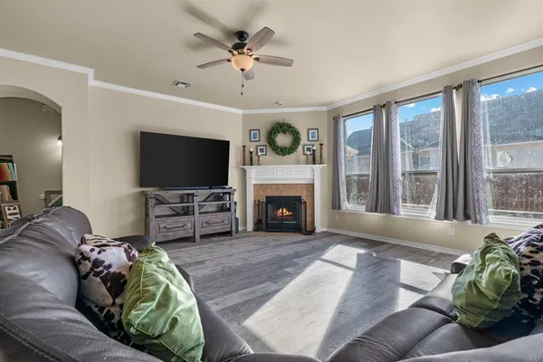 a living room with furniture a fireplace and a flat screen tv