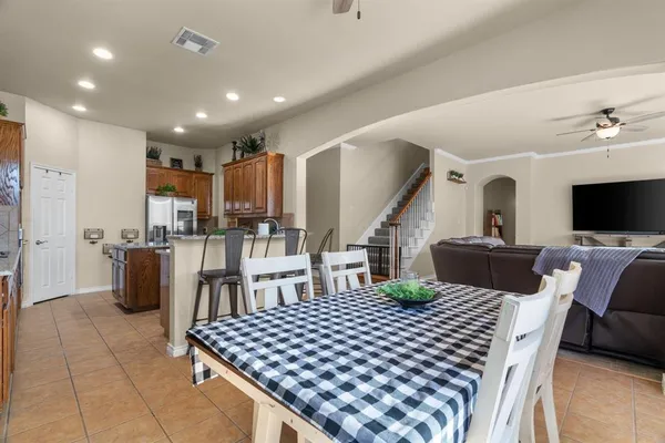 a living room with lots of furniture and kitchen view