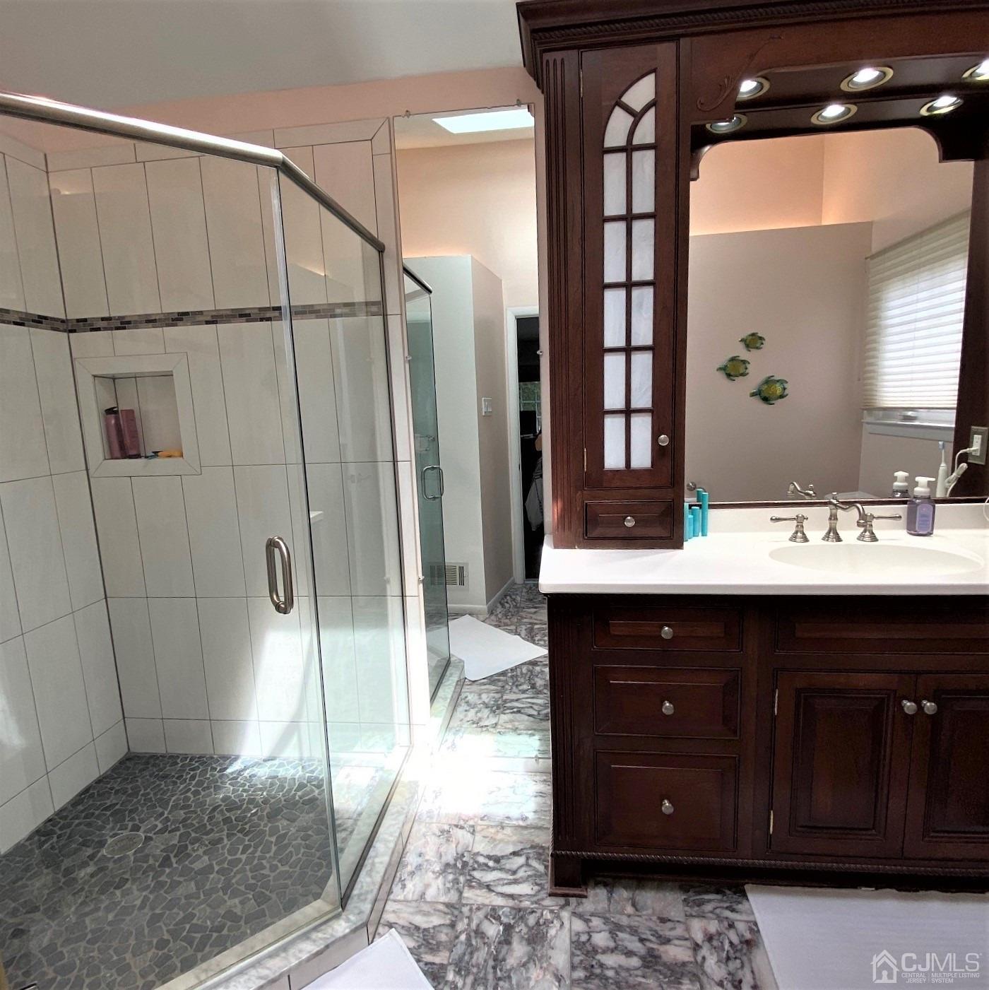 5 Timan Place Piscataway, NJ 08854 - Photo 15 of 27 a bathroom with a sink and a mirror