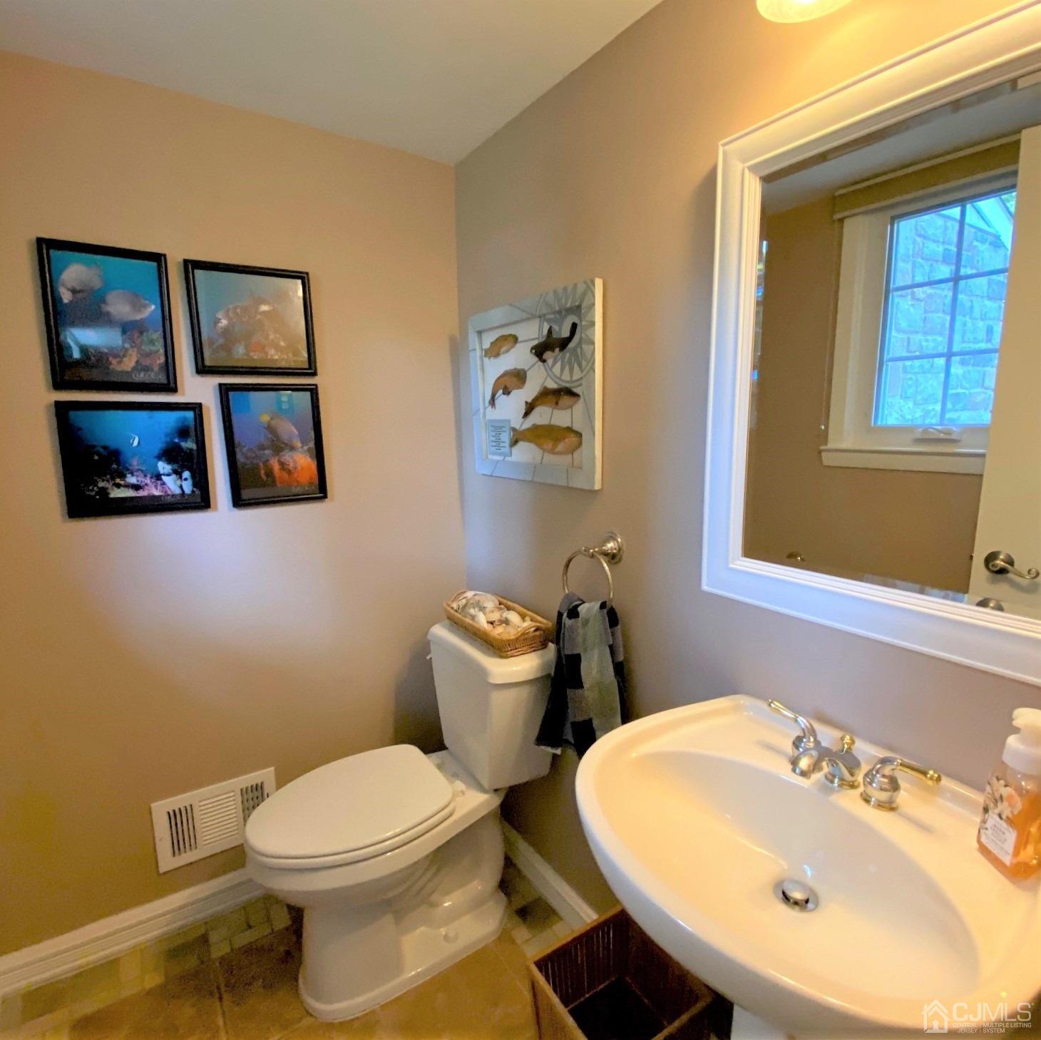 5 Timan Place Piscataway, NJ 08854 - Photo 17 of 27 a bathroom with a toilet sink and mirror