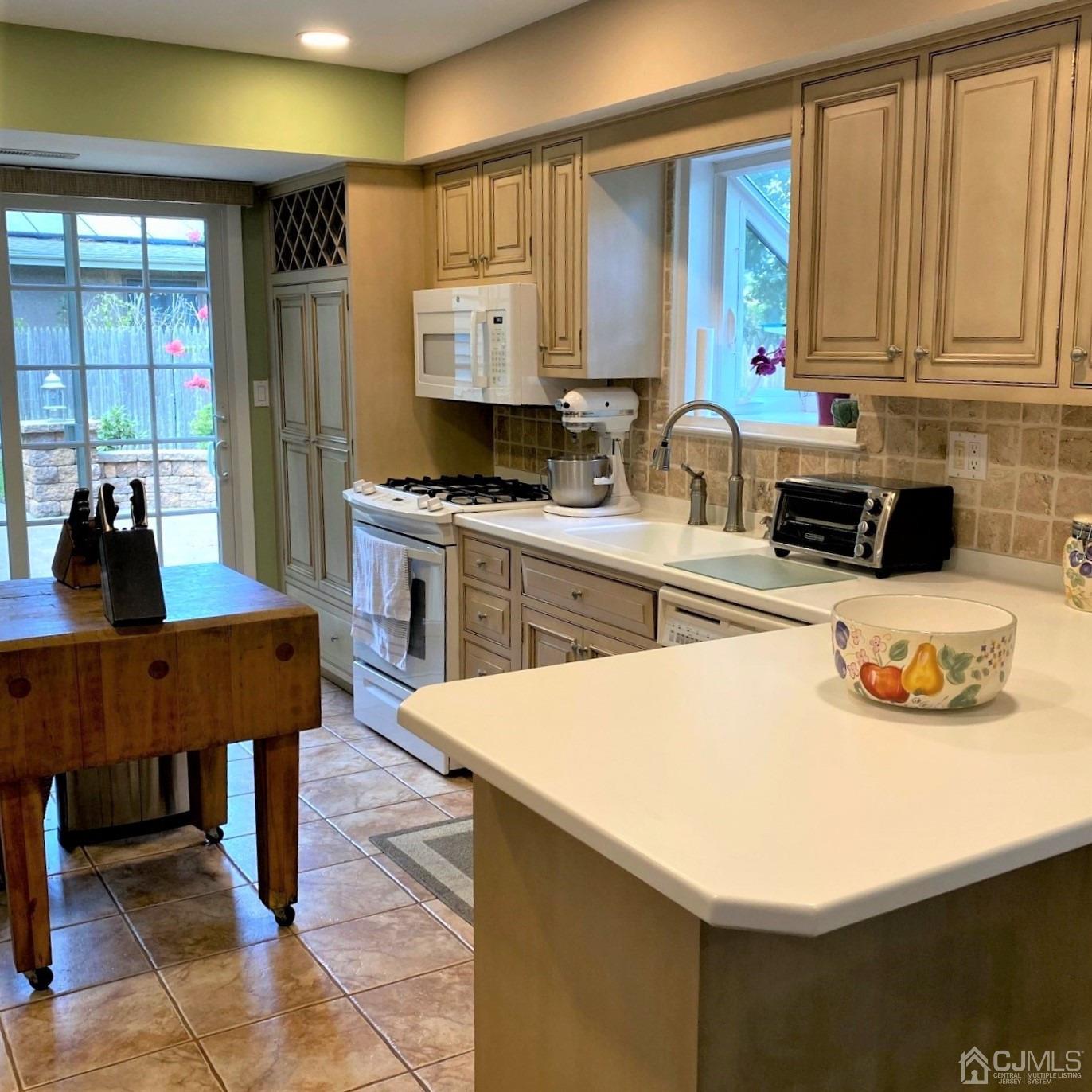 5 Timan Place Piscataway, NJ 08854 - Photo 21 of 27 a kitchen with stainless steel appliances a sink a table and chairs