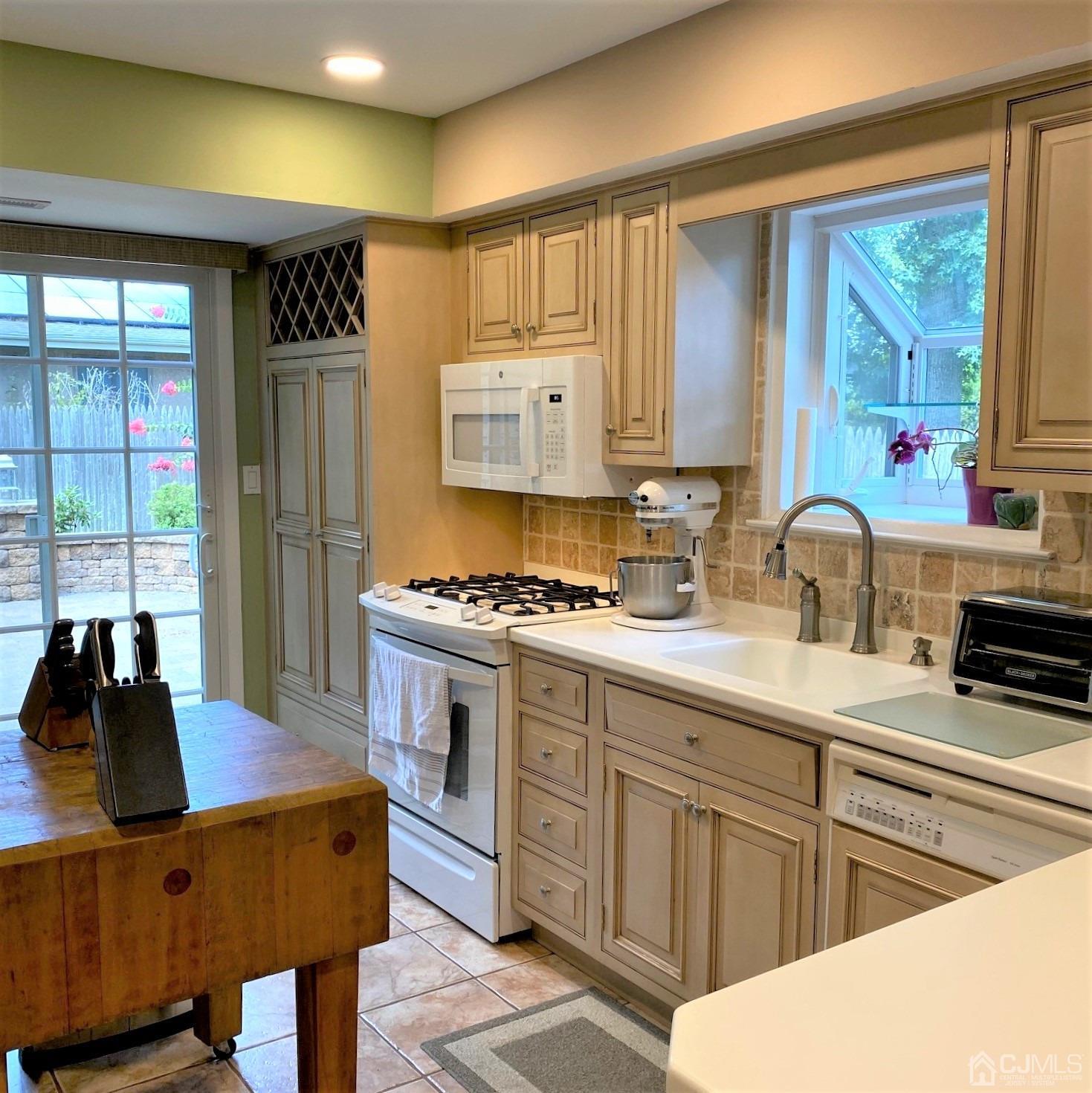 5 Timan Place Piscataway, NJ 08854 - Photo 22 of 27 a kitchen with stainless steel appliances granite countertop a stove a sink dishwasher and cabinets