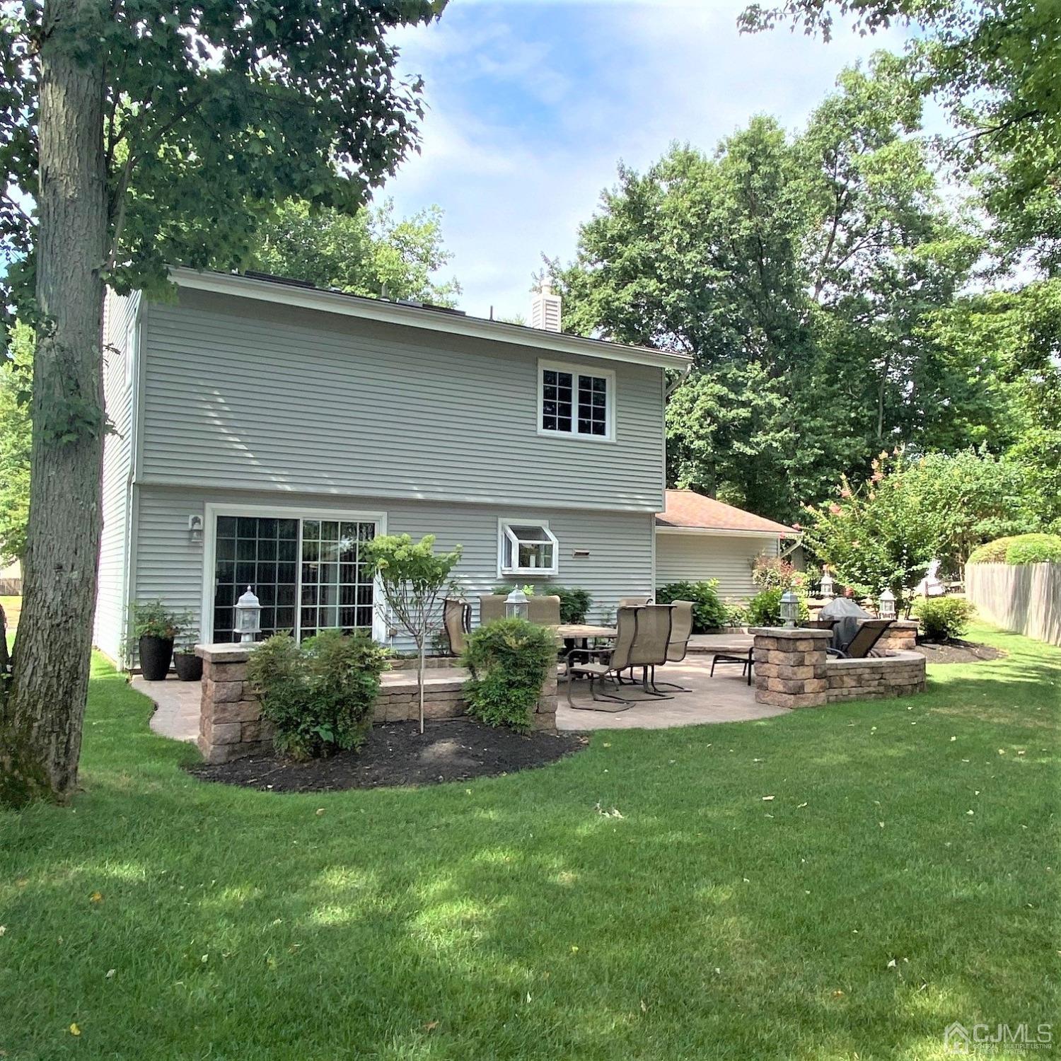 5 Timan Place Piscataway, NJ 08854 - Photo 3 of 27 a view of backyard of house with outdoor seating and green space