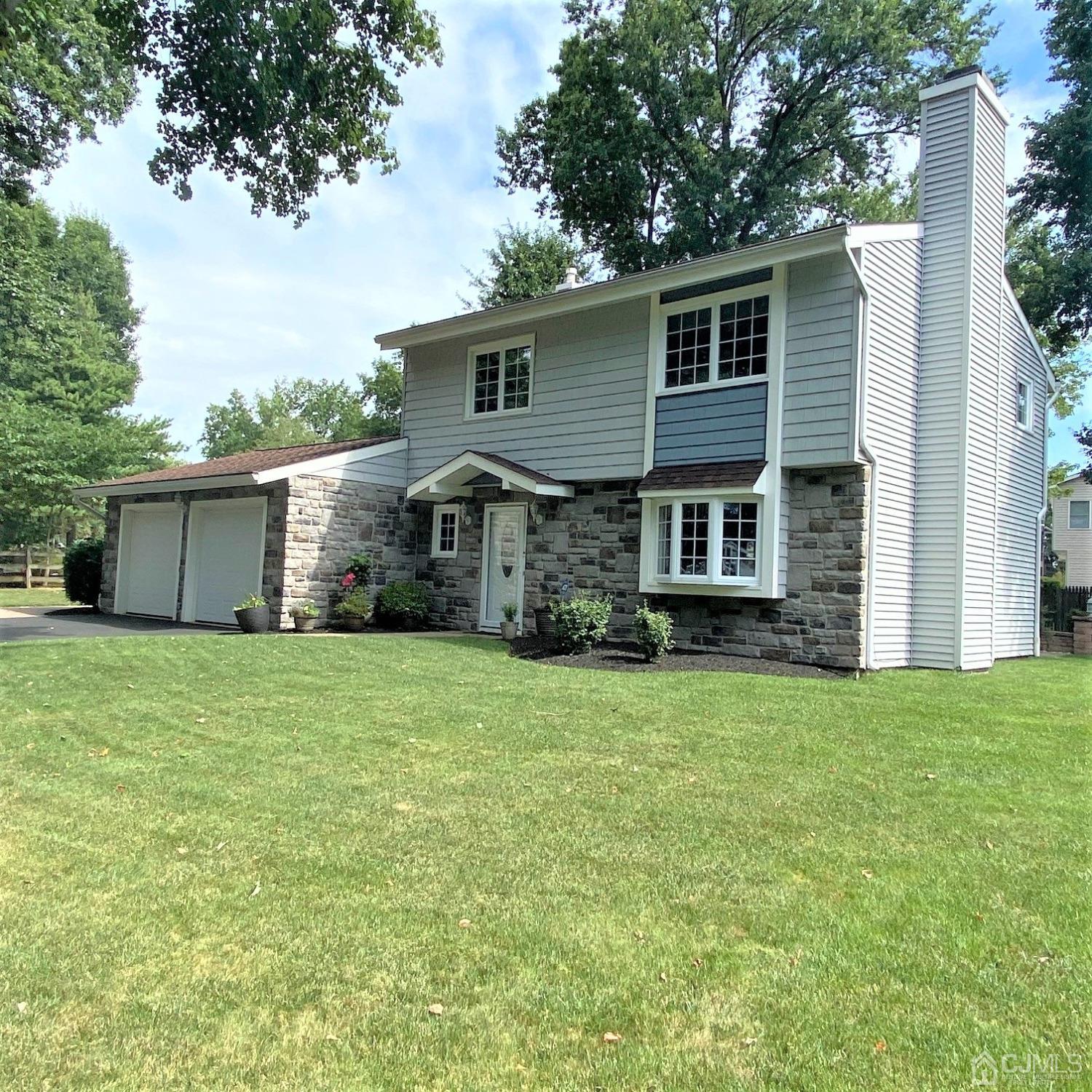 5 Timan Place Piscataway, NJ 08854 - Photo 6 of 27 a front view of a house with a garden