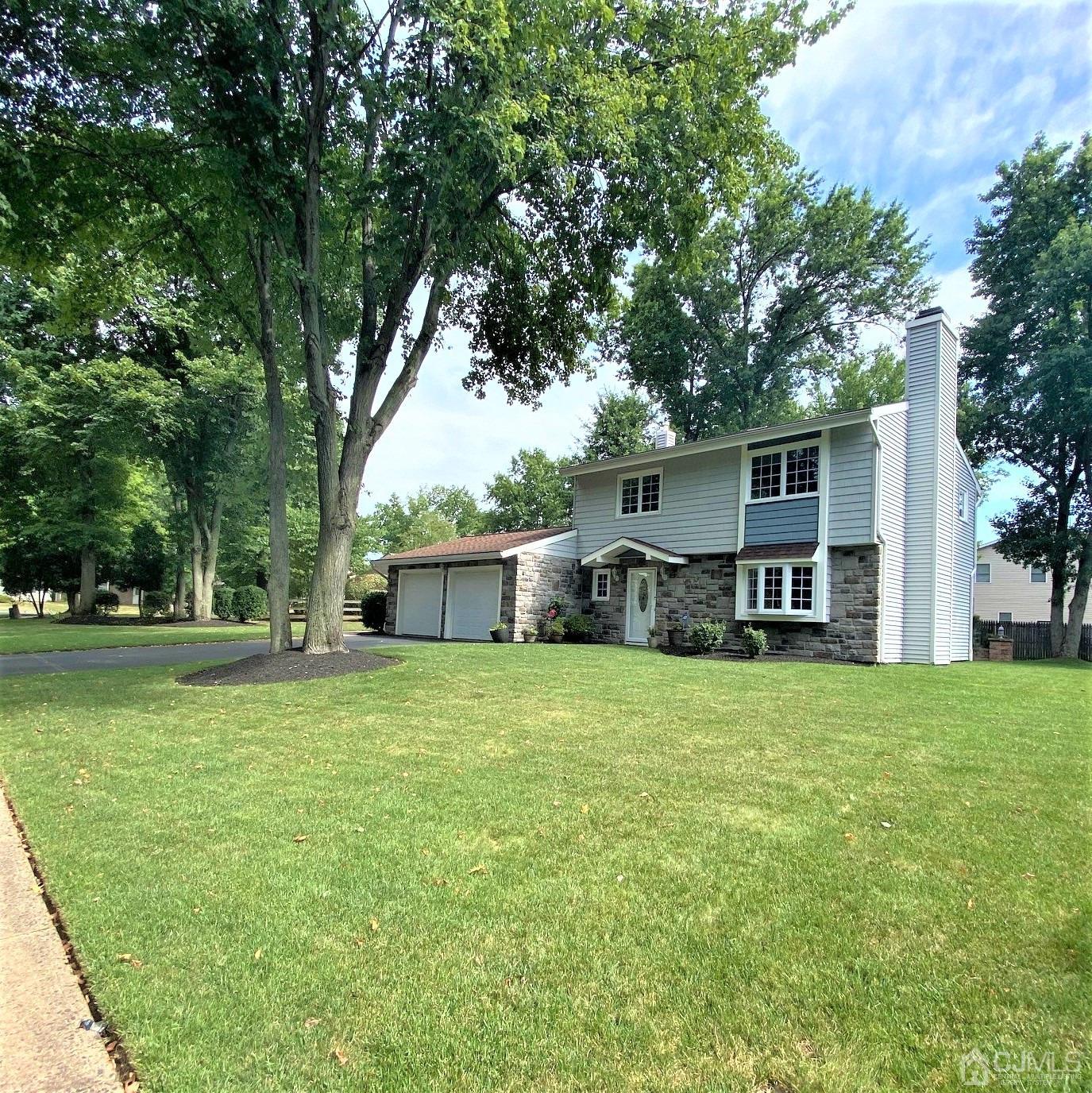5 Timan Place Piscataway, NJ 08854 - Photo 7 of 27 a front view of house with yard and trees