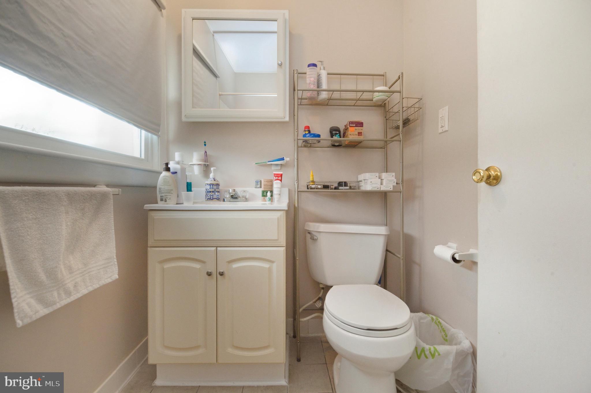 14 Buttercup Lane Willingboro, NJ 08046 - Photo 19 of 26 a bathroom with a sink a toilet and a window