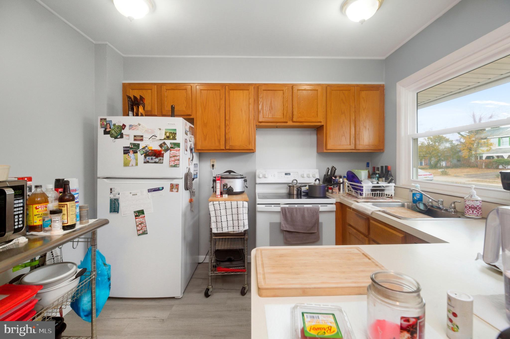 14 Buttercup Lane Willingboro, NJ 08046 - Photo 5 of 26 a kitchen with a refrigerator and a stove top oven