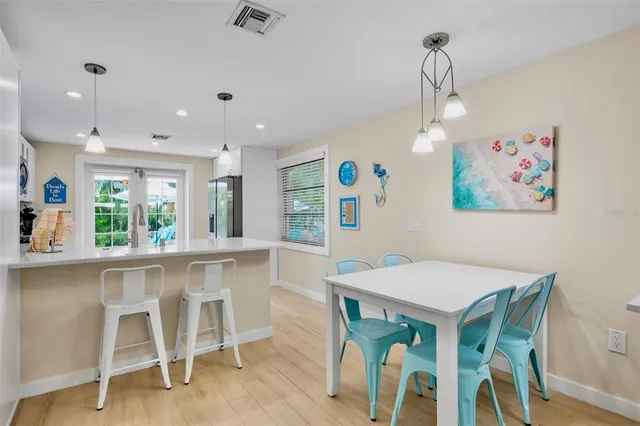 a kitchen with white cabinets and appliances