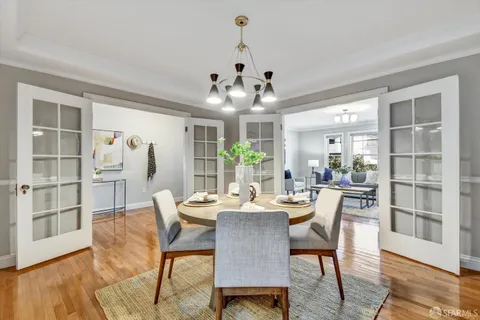 a view of a dining room with furniture and wooden floor