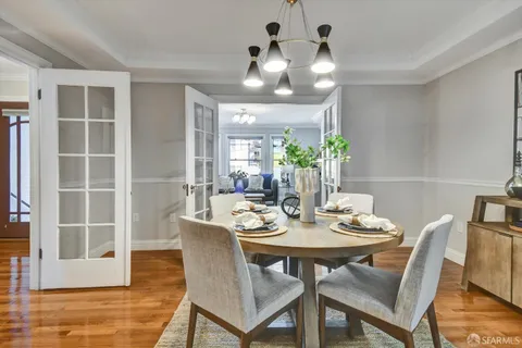 a kitchen with kitchen island granite countertop a sink cabinets and window