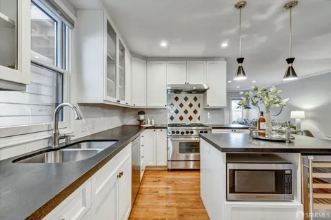 a kitchen that has a lot of cabinets in it