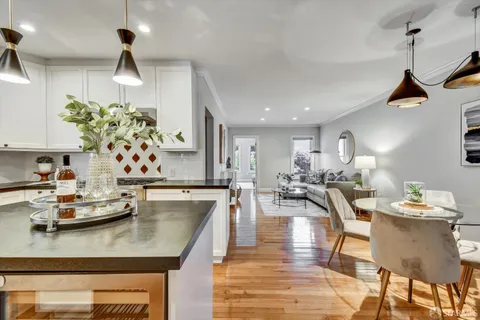 a view of a dining room with furniture wooden floor and chandelier