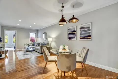 a living room with furniture a mirror and a table