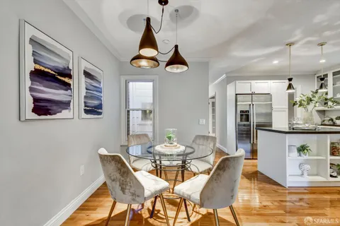 a bedroom with a bed and painting on the wall
