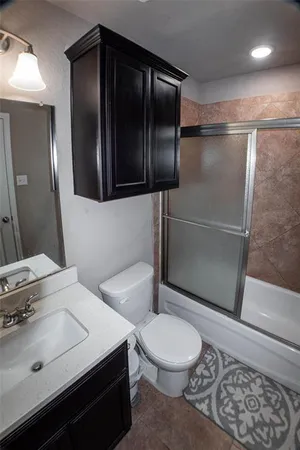 a bathroom with a toilet a sink and shower