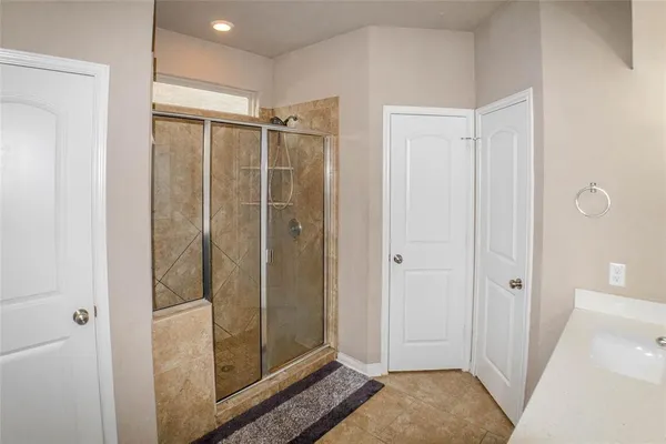 a bathroom with a shower and a sink