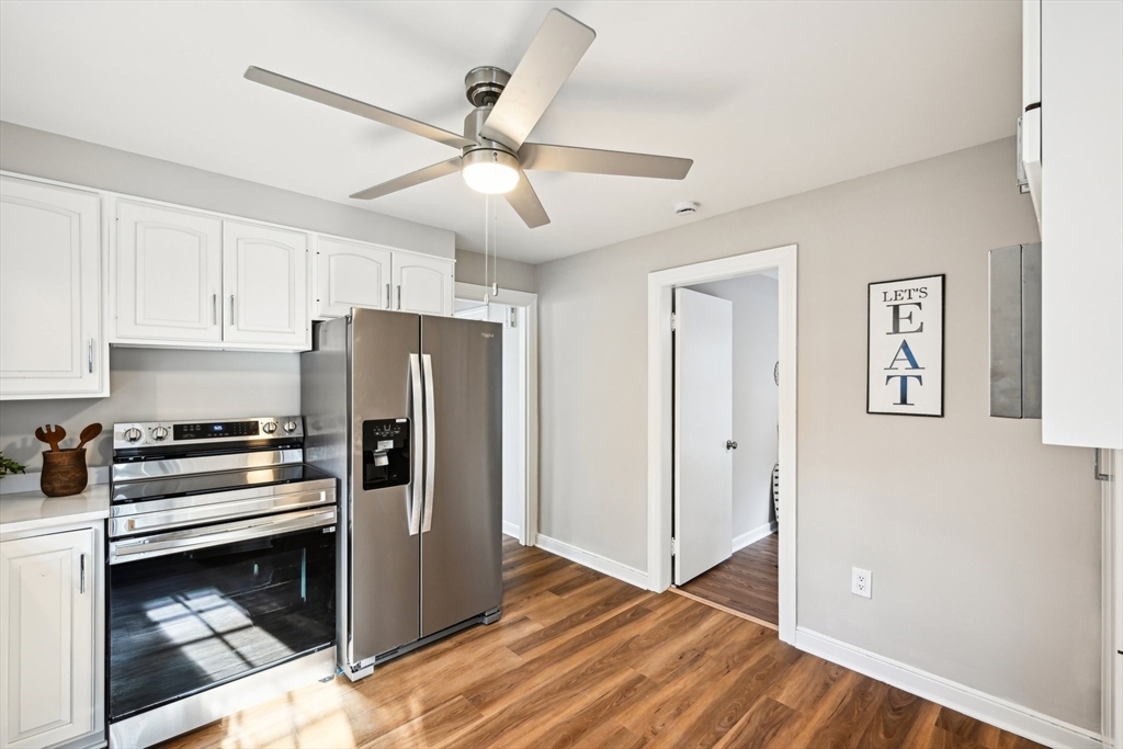 49 Dellwood Road Worcester, MA 01602 - Photo 15 of 27 a kitchen with a refrigerator a stove a microwave and white cabinets