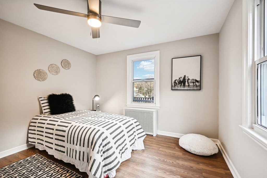 49 Dellwood Road Worcester, MA 01602 - Photo 22 of 27 a bedroom with a bed and wooden floor