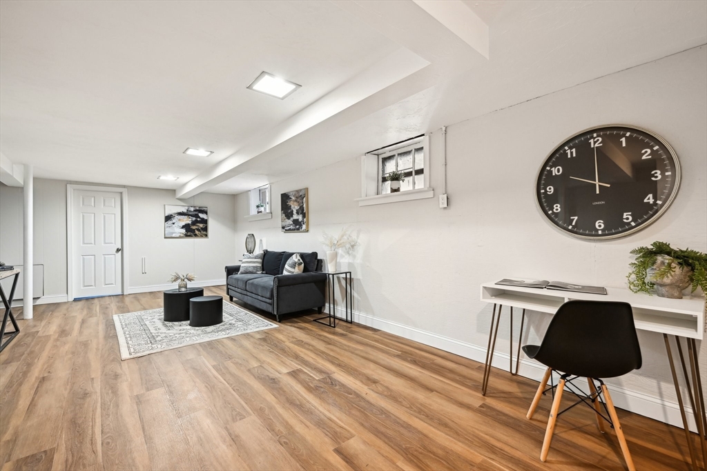49 Dellwood Road Worcester, MA 01602 - Photo 24 of 27 a bedroom with a bed and a chandelier
