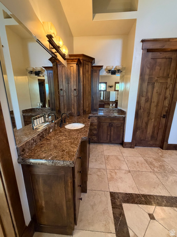 4536 North 475 East Provo, UT 84604 - Photo 44 of 65 Dual vanity with rich wood cabinetry, stone countertops, and integrated vessel sink