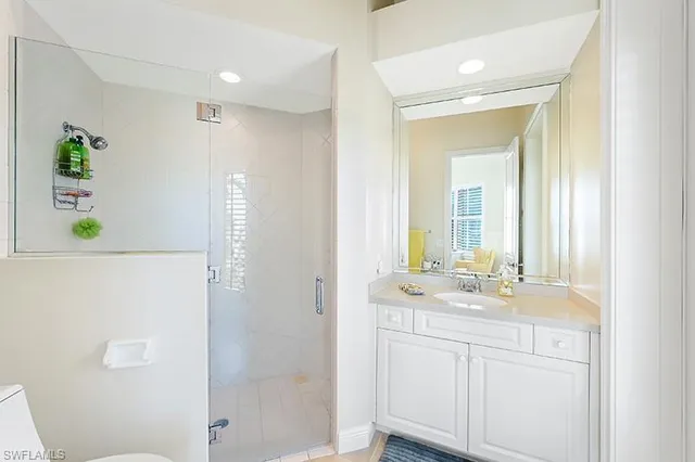 a bathroom with a sink a mirror a shower and a bathtub