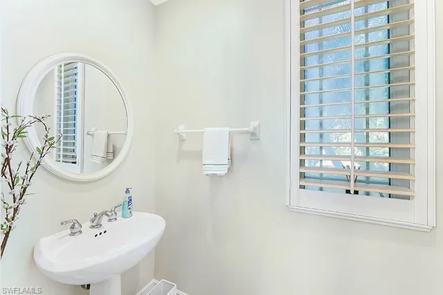 a bathroom with a sink a mirror and shower