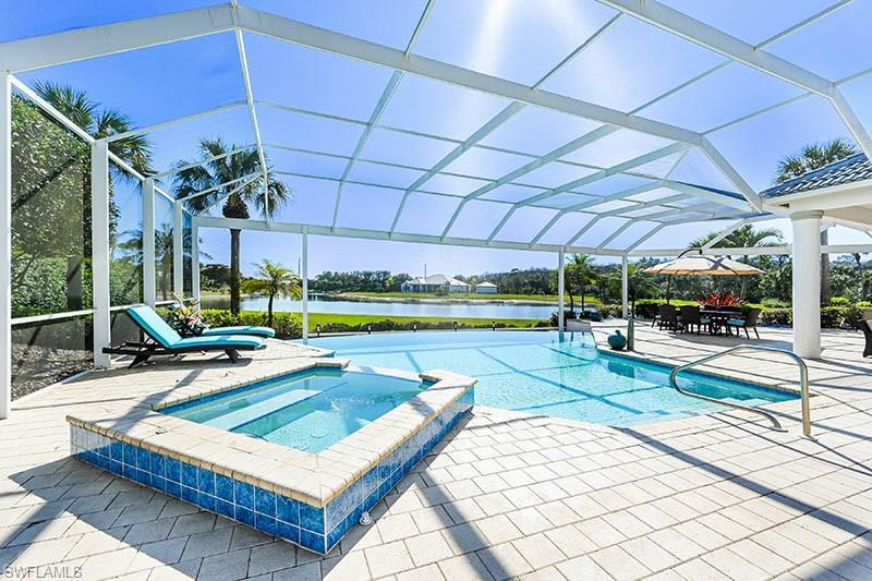 11234 5 Oaks Lane Naples, FL 34120 - Photo 24 of 34 a view of a swimming pool with a patio