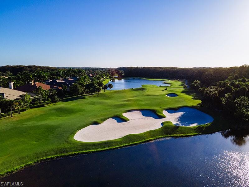 11234 5 Oaks Lane Naples, FL 34120 - Photo 28 of 34 a view of a golf course with a garden