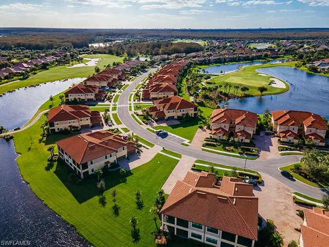 an aerial view of a house with a garden and lake view
