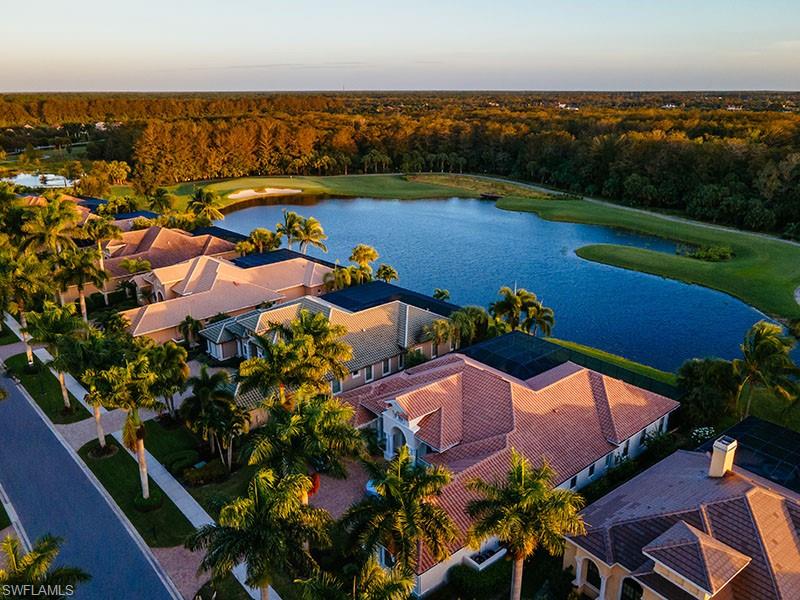 11234 5 Oaks Lane Naples, FL 34120 - Photo 31 of 34 an aerial view of a house with a garden and lake view