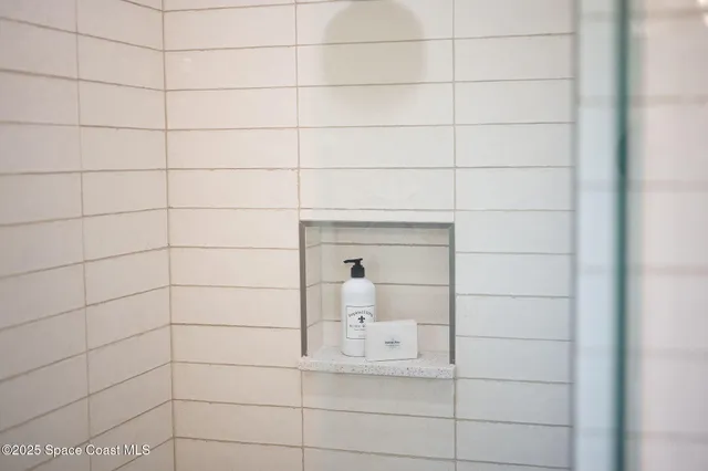 a bed sitting in a bedroom next to a lamp