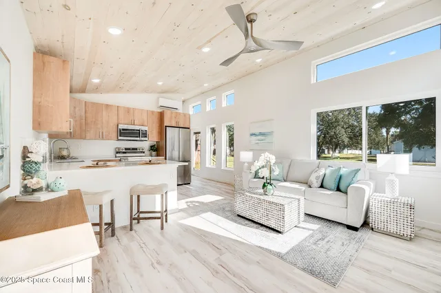 a living room with furniture and kitchen view