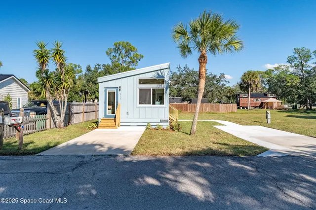 a view of a house with swimming pool and a yard