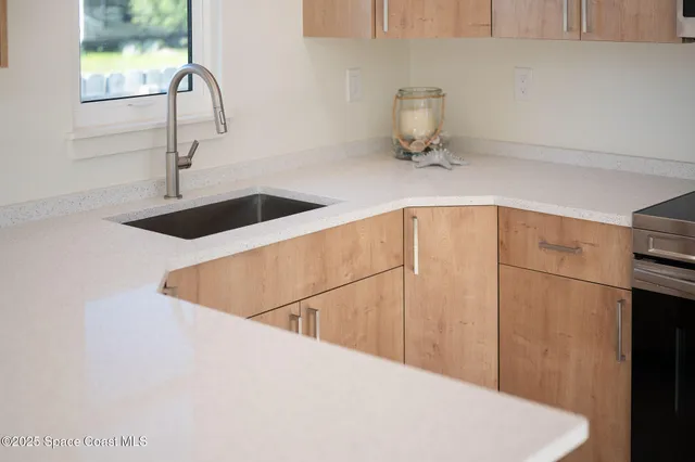 a kitchen with a sink and cabinets