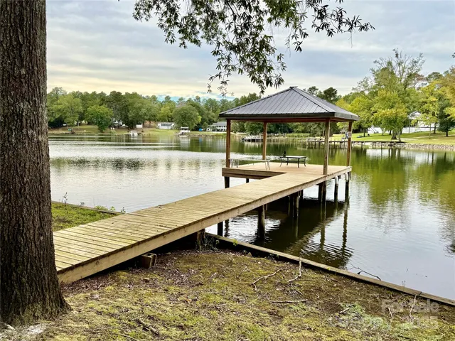 a view of a lake with couches in wooden floor