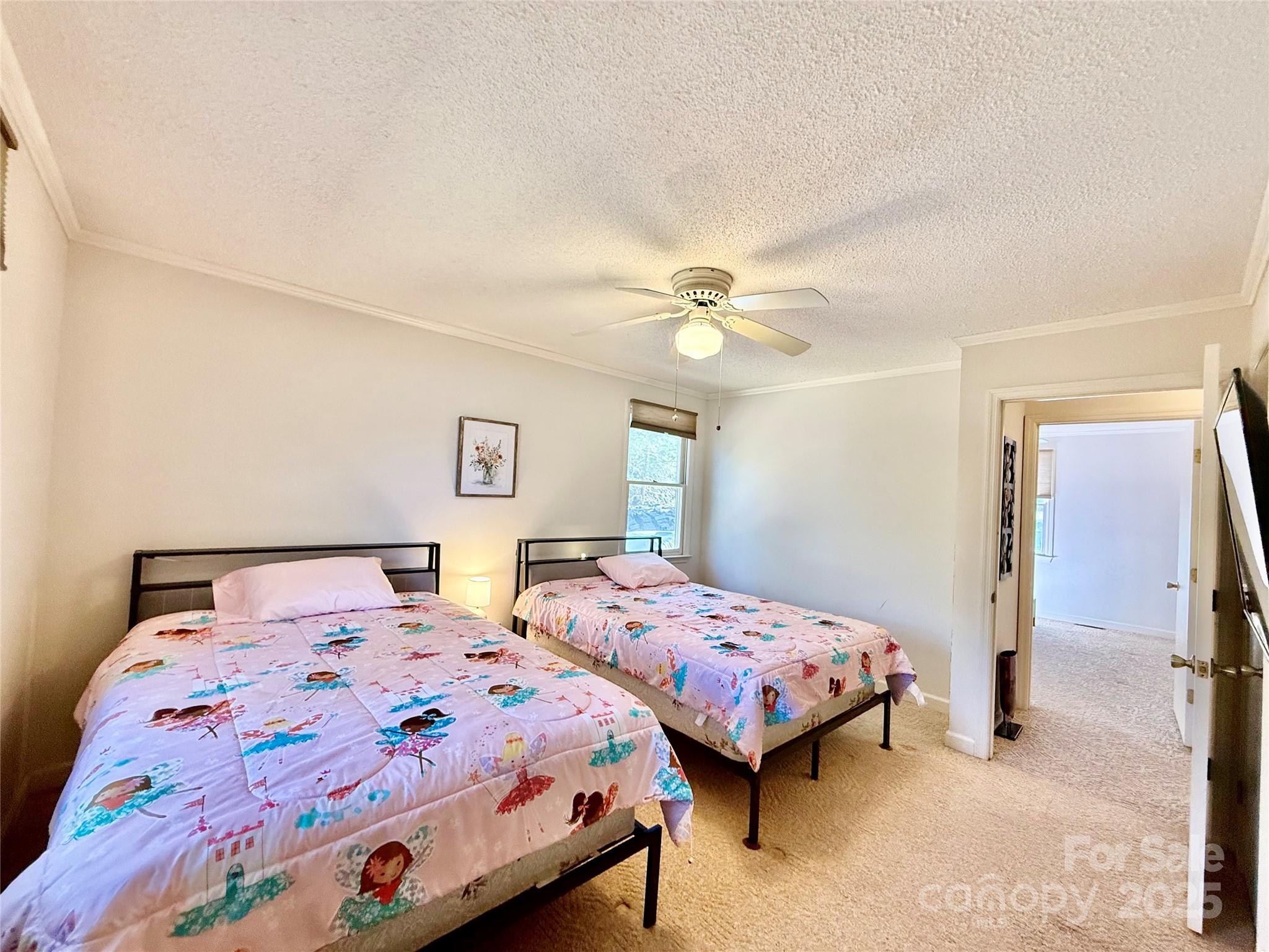 2178 Duck Cove Road Camden, SC 29020 - Photo 16 of 38 a bedroom with two beds and a chandelier