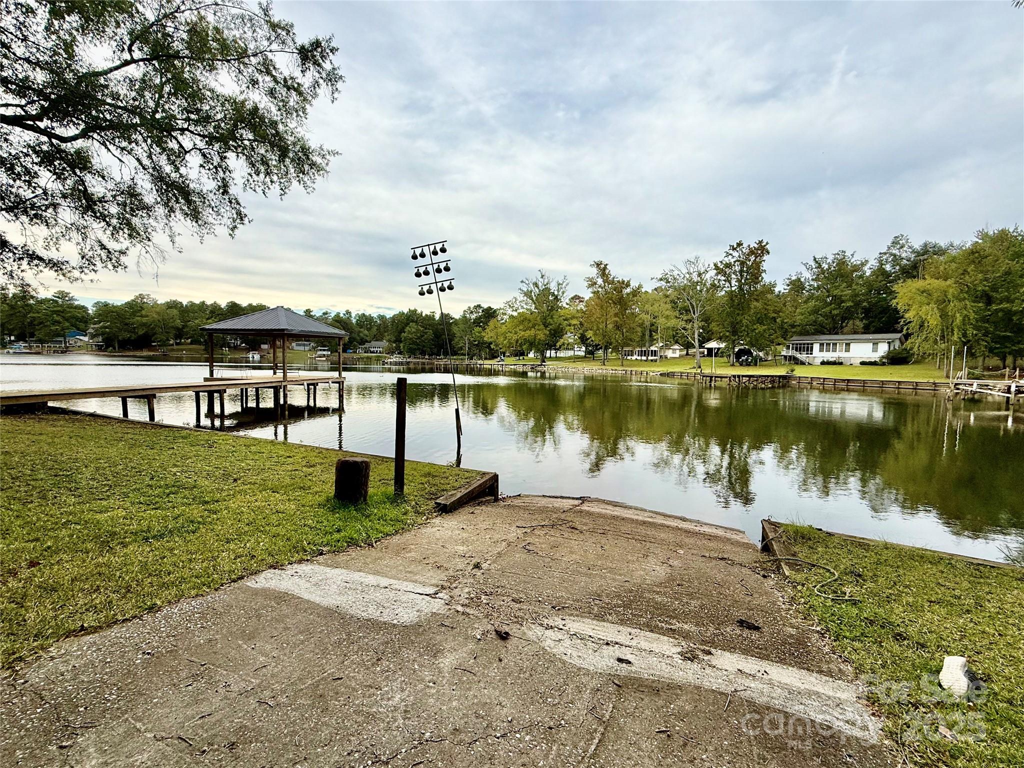 2178 Duck Cove Road Camden, SC 29020 - Photo 2 of 38 a view of a lake with a big yard and large trees