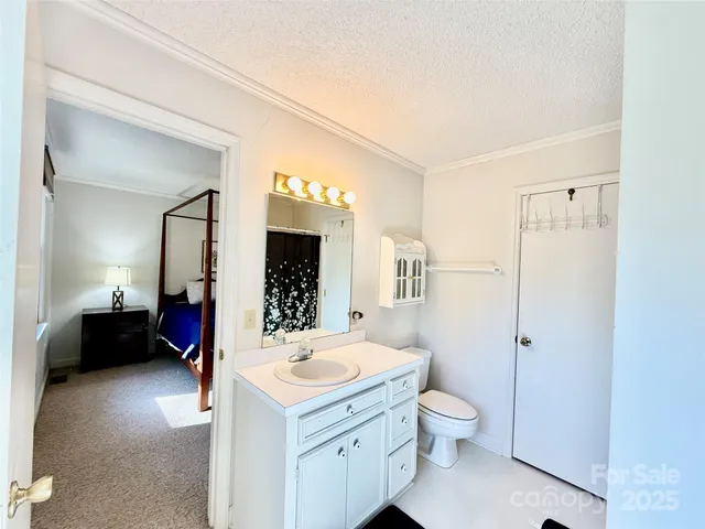 a spacious bathroom with a toilet sink and mirror