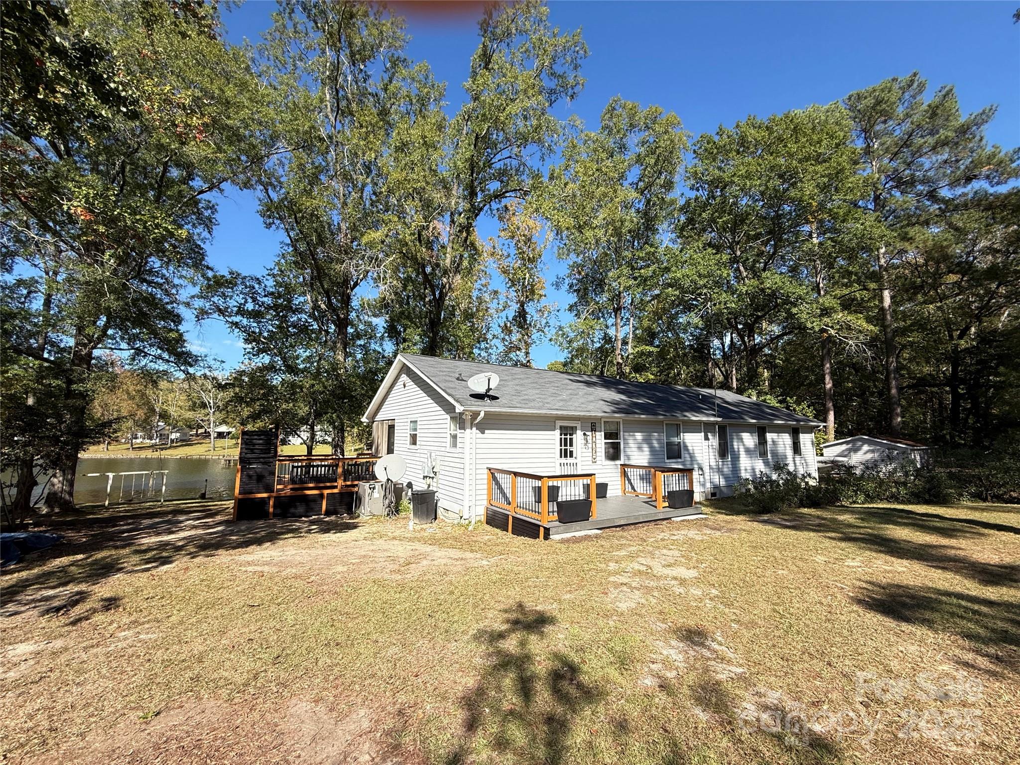 2178 Duck Cove Road Camden, SC 29020 - Photo 34 of 38 a front view of a house with a yard covered with snow and trees
