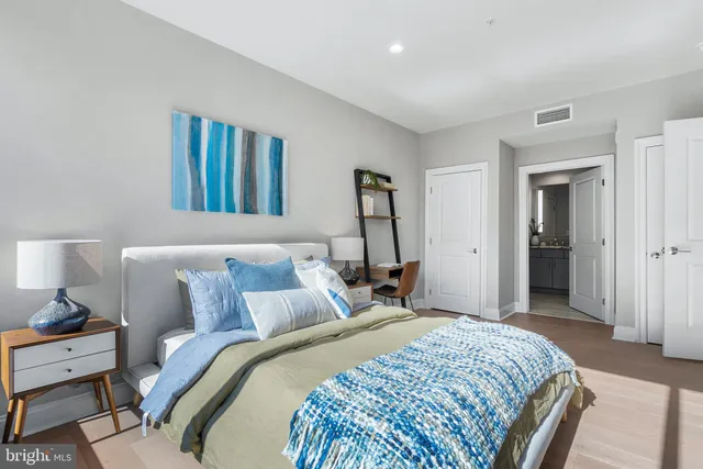 a bedroom with a bed and a lamp