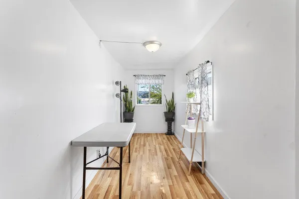 a view of a dining room with furniture and wooden floor