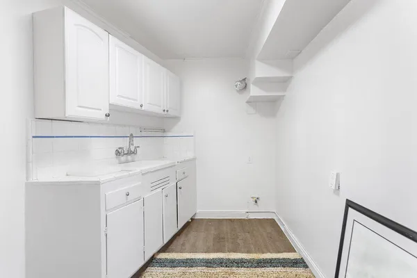 a room with a sink and cabinets