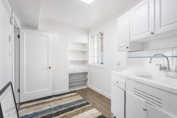 a kitchen with a sink and cabinets