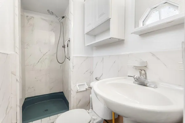 a bathroom with a sink toilet and shower