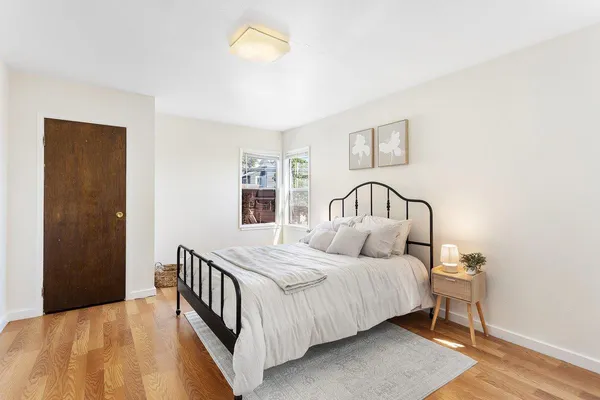 a bedroom with a bed and a window
