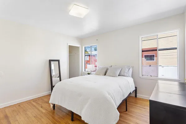 a bedroom with a bed and a window